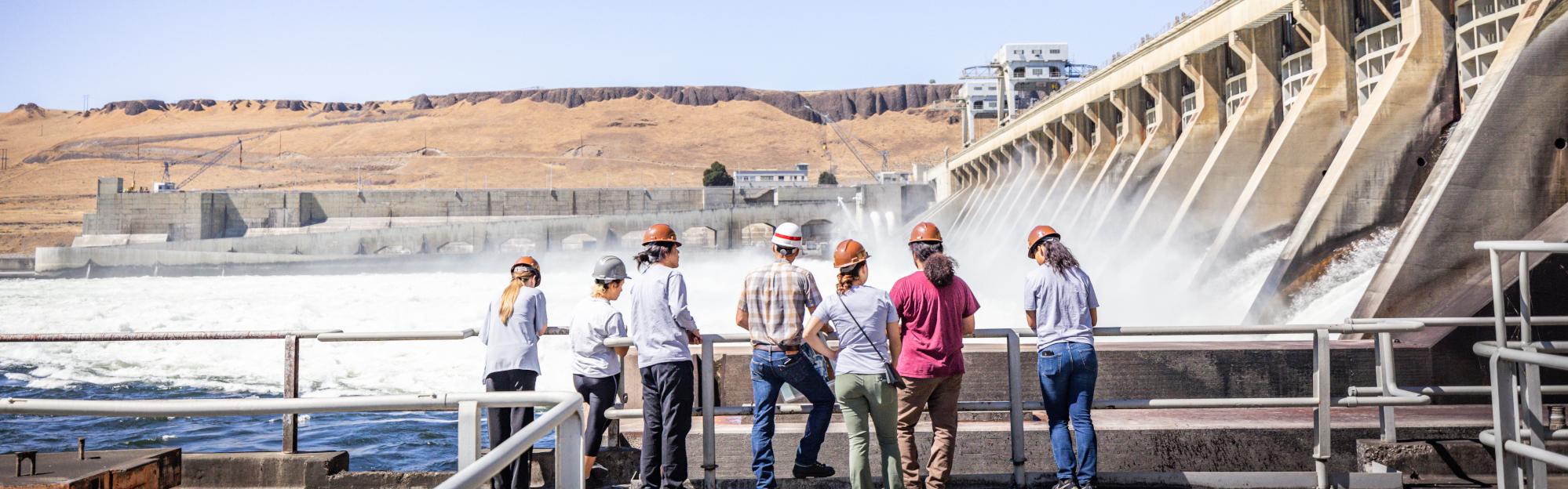 Group of people looking at a hydroelectric dam